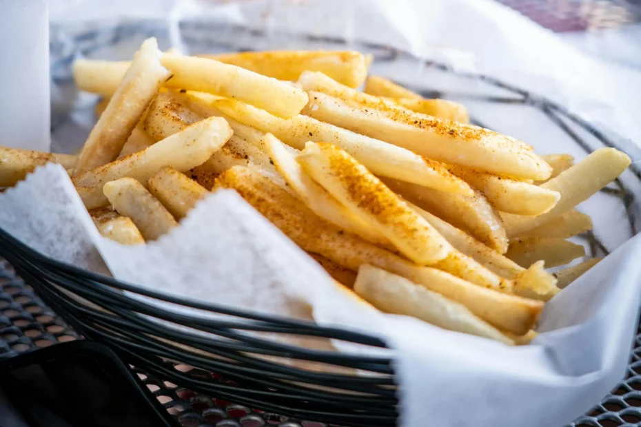 A basket of potato chips on food wrapping paper