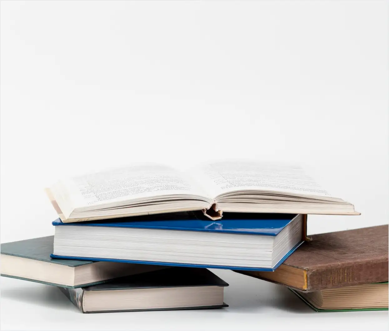 Some books closed and open on the floor